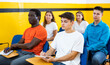 © JackF - Women and men sitting at desks and listening to lecture in taxi training school.