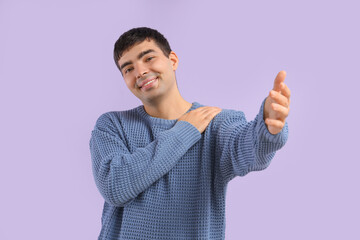 Wall Mural - Young man opening arm for hug on lilac background