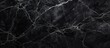 A closeup of a monochrome pattern resembling black marble with white veins, capturing the beauty of natures intricate design