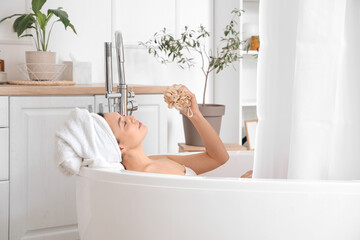 Poster - Relaxed young woman with loofah taking bath at home