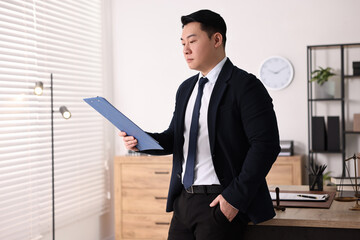 Wall Mural - Portrait of confident notary with clipboard in office