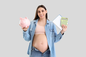 Wall Mural - Young pregnant woman with piggy bank, notebook and calculator on light background. Maternity Benefit concept