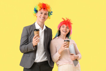 Sticker - Business people in funny wigs with coffee cups on yellow background. April Fools' Day celebration