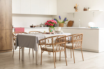 Wall Mural - Dining table with Easter eggs, tulips and dinnerware in kitchen