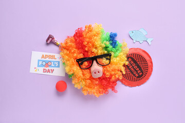 Sticker - Clown wig with funny glasses, whoopee cushion and festive postcard for April Fools Day on lilac background