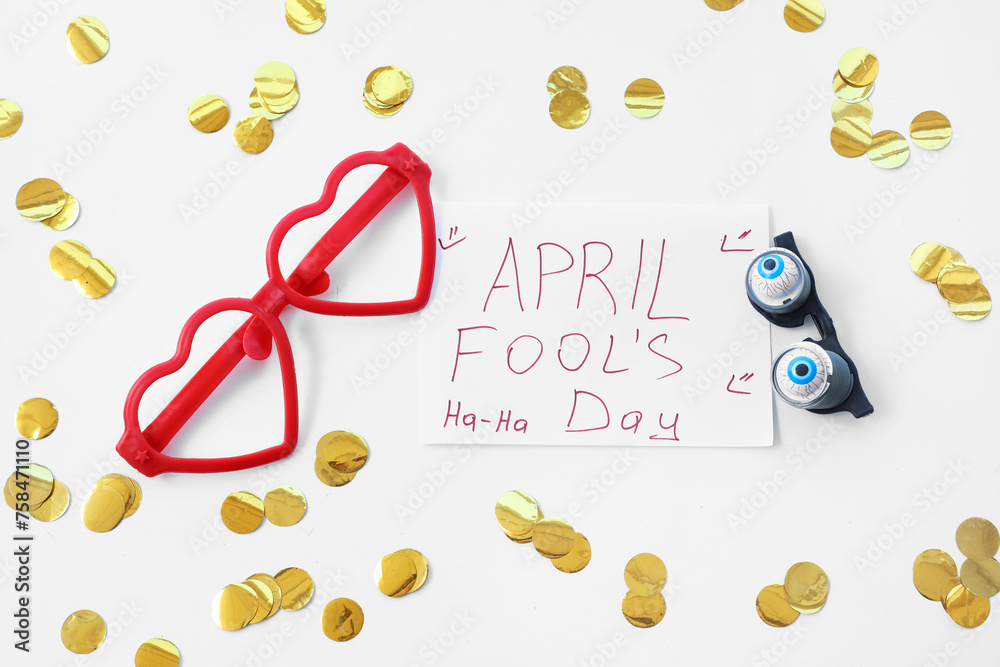 Poster with text APRIL FOOL'S DAY and novelty glasses on white background