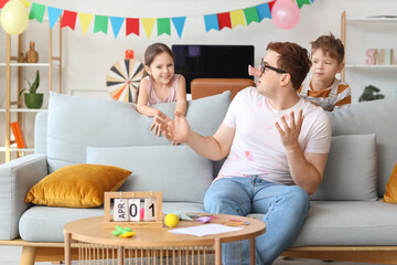 Wall Mural - Little children pranked their father with funny disguise at home. April Fool's Day prank