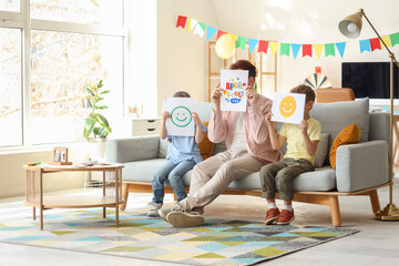 Sticker - Father and his children with April Fool's Day posters at home