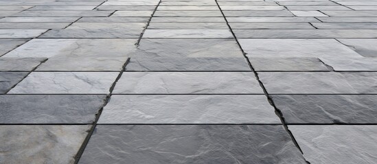 Poster - A detailed shot of a gray tiled floor made from composite material, with parallel rectangular planks resembling wood flooring, similar to a road surface