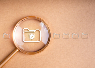 Poster - Data protection, safety information, cyber security concept. Shield icon on digital document folder file icon expanded by magnifying glass lens on desktop display, recycle background with copy space.