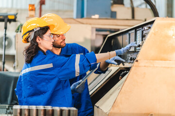 Wall Mural - Artificial intelligence robotic technician concept, Factory engineer inspecting on machine with smart tablet. Worker works at heavy robot arm. Welding with remote system in an manufacturing industrial