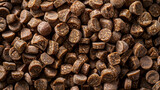 Fototapeta  - Macro shot of large brown dog food pellets piled up, showcasing texture and color. Backdrop, background.