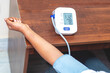 selective focus of a lady measuring blood pressure on a digital Sphygmomanometer. 