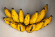 A bunch of fresh ripe bananas on a wooden background. Bananas are a nutritious fruit that has many health benefits. 