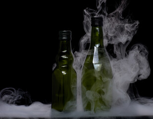 Wall Mural - Olive green glass bottle filled with smoke and surrounded with swirling mist and fog