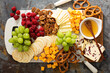 Cheese and snacks platter with honey and fresh fruit