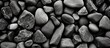 A closeup monochrome photo of a pile of rocks, showcasing the intricate pattern of cobblestones and gravel, a beautiful still life of building materials