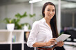 © Tasneem/peopleimages.com - Happy, tablet and portrait of business woman in office for creative research on internet. Smile, confident and professional Asian female designer with digital technology for project in workplace.