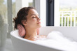 © Wavebreak Media - Young woman enjoys a relaxing bath at home, eyes closed