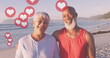 Image of hearts over happy senior african american couple on sunny beach
