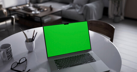 Laptop place on living room table, Green screen display, Close up monitor of notebook with mock up