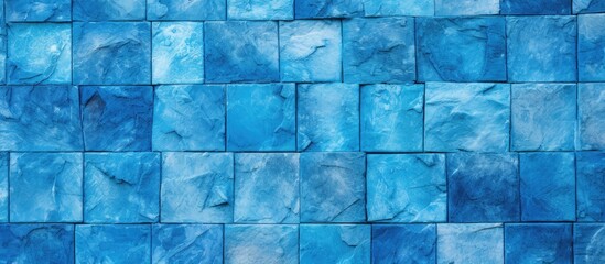 Poster - A close up of a blue rectangular tile wall with shades of azure and aqua, creating a symmetrical pattern resembling an art piece. The electric blue tints add depth to the flooring design