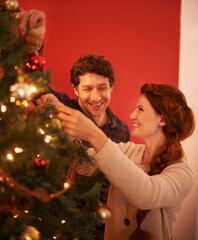 Poster - Couple, tree and christmas with smile, decoration and celebration for holiday spirit. Man, woman and love with happy marriage, relationship and romance with ornament for vacation break and care