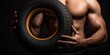 In pursuit of peak performance, a muscular athlete utilizes tires as part of his training arsenal, pushing his limits.