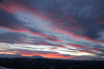 Wall Mural - Cloudy sky at sunset above the mountain range