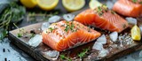 Fototapeta Las - Traditional Good Friday fish food, Easter food concept - Fresh salmon steak fillet on a board in the kitchen on the table, decorated with ice cubes and lemon slices, top view