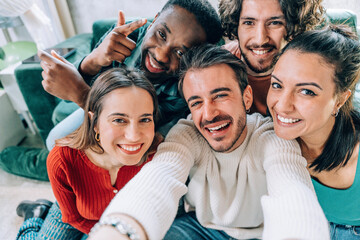 Happy group of young people taking selfie picture indoors - Smiling guys laughing at camera together - Youth community and technology concept