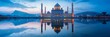 A majestic mosque reflected perfectly in the still waters of a nearby lake, under the tranquil twilight sky