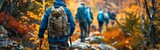 Fototapeta Londyn - A diverse group of individuals equipped with hiking gear are trekking through a dense forest surrounded by tall trees and greenery. They are navigating the rugged terrain and enjoying an outdoor adven