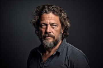 Canvas Print - Handsome middle aged man with long grey hair and beard in a studio portrait