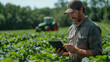 A farmer uses a digital tablet computer in the field of growing natural products, the use of modern technologies in agricultural activities.
