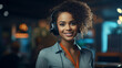 young afro-american woman with a blue blouse wearing a headset in an office possibly working in customer service or at a video conference