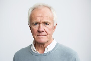 Canvas Print - Portrait of a senior man looking at camera isolated on a white background