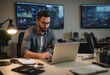 © natakot - A man is deeply focused on his work at a laptop during late hours. The office background suggests a busy work environment.