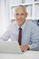 Poster - Happy, portrait and senior businessman with laptop in office for social media, search or web communication. Face, smile and elderly male entrepreneur with computer for research, email or b2b network