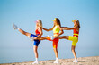 © maxbelchenko - Beautiful women are dancing on the beach. Fitness, training, aerobics and people concept. Active sport.