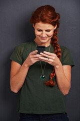 Poster - Smile, reading and woman in studio with phone for social media, online chat or networking. Communication, internet and happy girl with smartphone, typing and scroll on mobile app with dark background