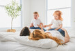 © Louis-Paul Photo - happy family mother, father and children having fun in bed in bedroom at home