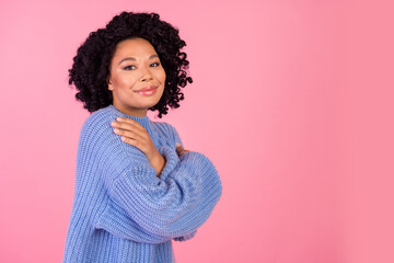 Wall Mural - Photo portrait of lovely young lady hug self enjoy warmth dressed stylish blue knitted garment isolated on pink color background