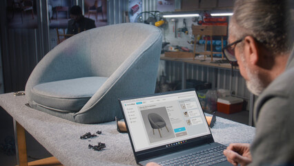 Craftsman uploads pictures of stylish wooden chair to online store website using laptop. Small business owner adds photos of furniture to the internet marketplace for sale. Entrepreneurship concept.