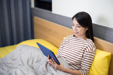 Wall Mural - Woman use digital tablet on bed