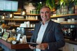 © sambath - full body of a business man restaurant manager 50 years old smiling with a tablet device