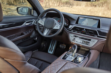 Wall Mural - Shift lever, car steering wheel and sensors. Inside a modern car view, city car interior background