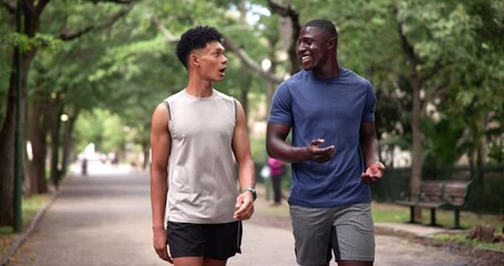 Wall Mural - Men, friends and talking for exercise in park or athlete workout or bonding conversation, cardio or wellness. Male people, healthy and relax on forest street in Australia or training, chat or walk