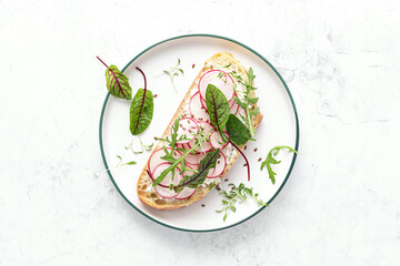 Wall Mural - Radish sandwiches with cottage cheese and fresh green leaves, top down view