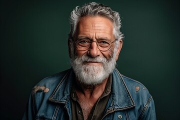 Portrait of a handsome senior man wearing jeans jacket and glasses.